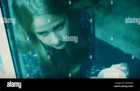4k Sad Child Girl Looking through the Glass while Raining Stock Video Footage - Alamy