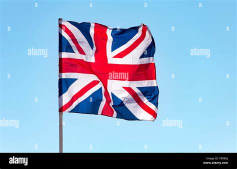 London, Great Britain flag waving against blue sky, the British flag Stock Photo - Alamy