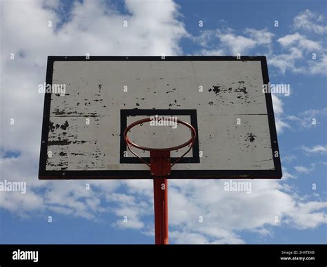 A photo of basketball hoop on an outdoor court with sky and clouds background Stock Photo - Alamy