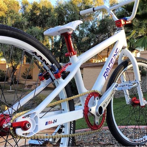 a white bike with red and blue spokes parked in front of a house