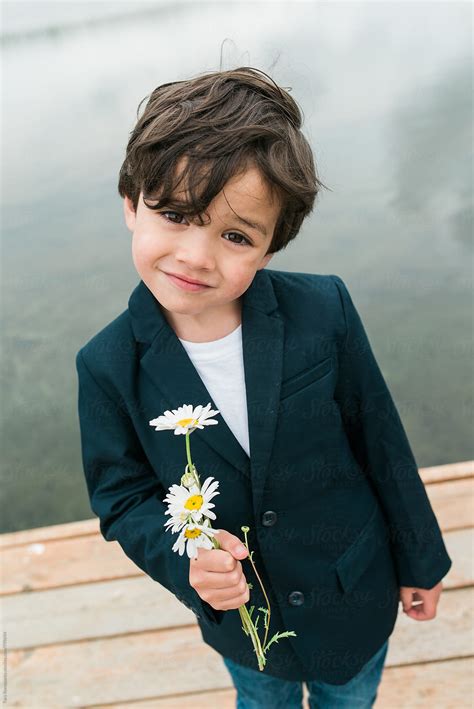 "Little Boy With Attitude And An Offering Of Flowers" by Stocksy ...