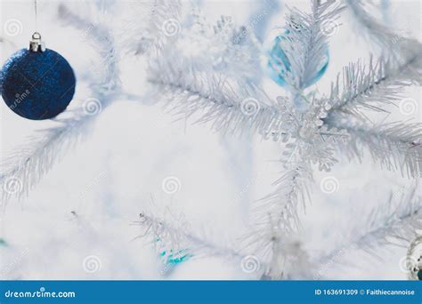 Christmas Tree with White Frosted Snow Style with Snowflakes Decorations and Blue and Silver ...