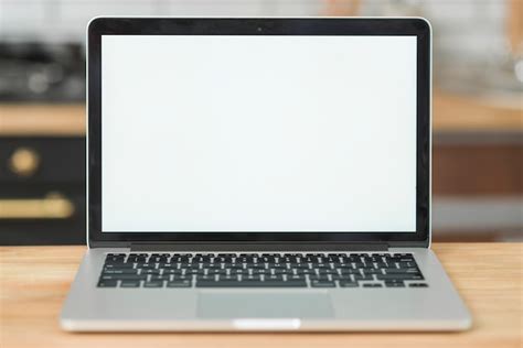 Free Photo | Modern laptop with blank white screen on wooden table