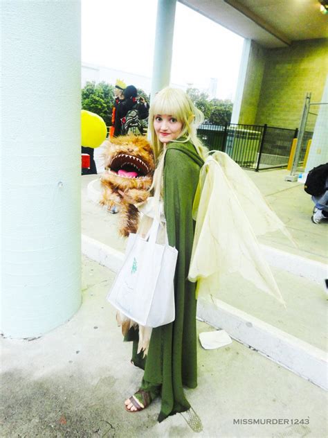 a woman is dressed up as a monster and holding a shopping bag in her hand