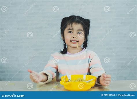 Asian Baby Girl Enjoy Happy Using Cutlery Spoon and Fork Eating Delicious Noodle in Kitchen on ...