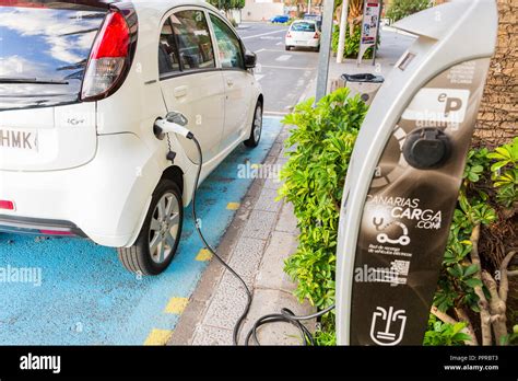 Peugeot Ion electric car plugged in at a public charching station on ...