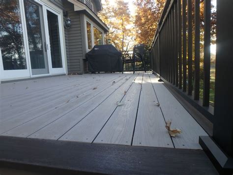 Here is a Slate Gray Azek deck with a Dark Hickory border. This deck features black Westbury ...