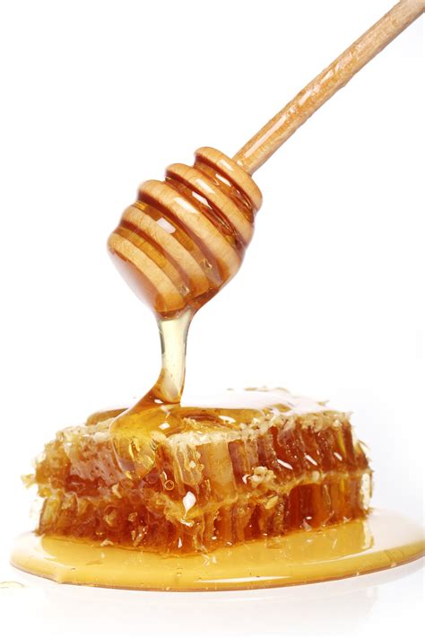 Free Photo | Honey dripping from a wooden spoon