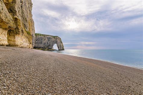 Scenic view of Etretat cliffs in Normandy France with pebble beach against dramatic sky 15607162 ...