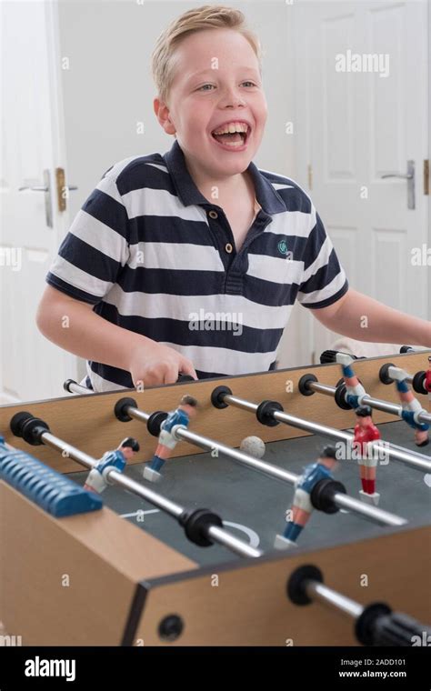 Boy with cerebral palsy. 10-year-old boy with cerebral palsy playing table football with a ...