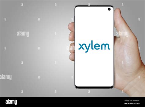 Logo of public company Xylem Inc. displayed on a smartphone. Grey background. Credit: PIXDUCE ...