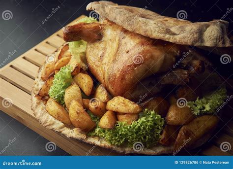 Whole Baked Chicken with Potatoes Close-up on a Table Stock Photo - Image of gourmet, brown ...