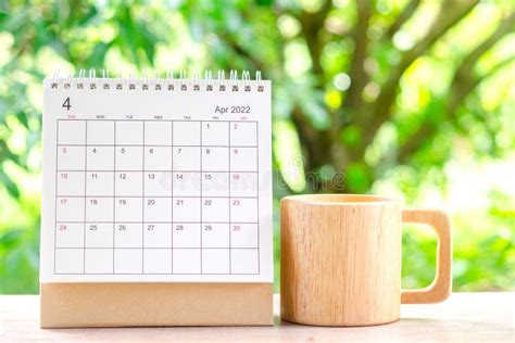 April Month, Calendar Desk 2022 for Organizer To Planning and Wooden Coffee Cup on Wooden Table ...
