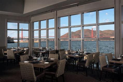 a restaurant with large windows overlooking the water