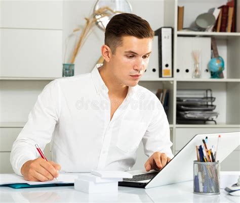 Guy in White Shirt Works at Table with Laptop in Office Stock Photo - Image of modern, lifestyle ...