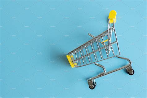 Shopping cart on blue background featuring cart, shopping, and shopping cart | Business Images ...