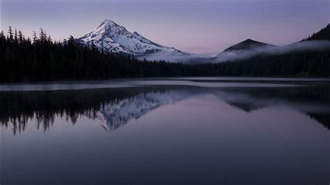 Landscape View Of White Covered Mountains Peak In White Clouds Sky ...