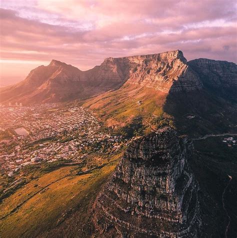 an aerial view of the city and mountains in cape town, south africa at sunset