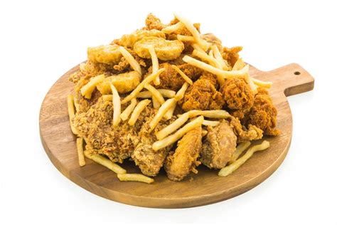 French fries and fried chicken on wooden plate 2234853 Stock Photo at ...