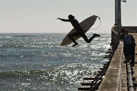 Surfers jump off the Cayucos, CA pier. | Surfers and boogie … | Flickr