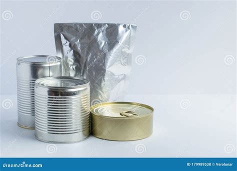 Metal Cans of Different Sizes, Metallized Flexible Packet on a White ...