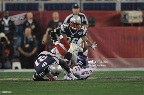 Plaxico Burress of the New York Giants fumbles against Randall Gay of ...