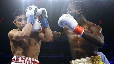 Crawford wins by TKO when Khan can't continue