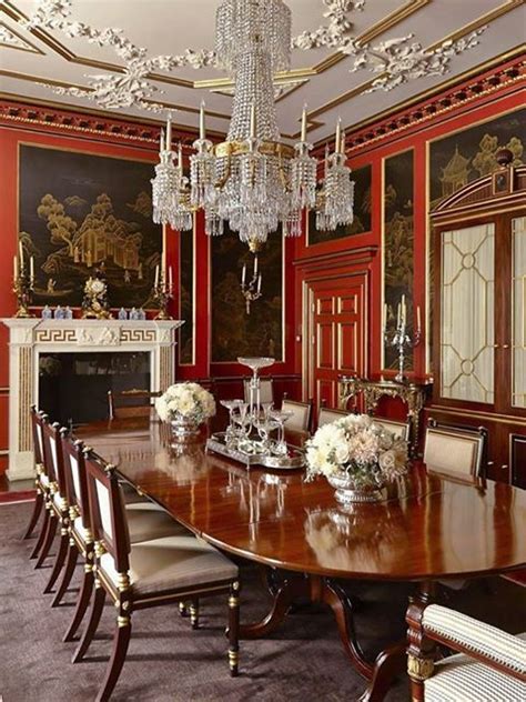 A regency decorated dining room with red walls and black and gold ...