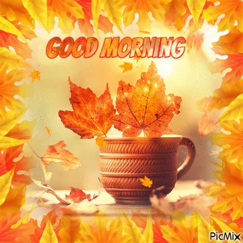 a cup filled with autumn leaves and the words good morning written in front of it