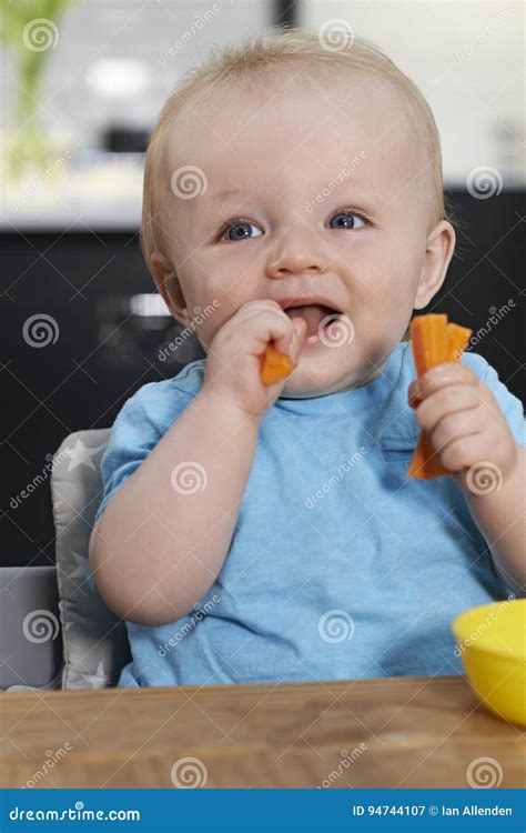 Happy Toddler Sitting at Table Eating Fresh Carrots Stock Image - Image of meal, food: 94744107