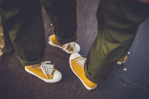 Two People Wearing Yellow-and-white Low-top Chucks · Free Stock Photo