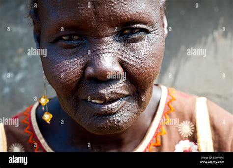 Woman belonging to the Nuer tribe with facial markings on the head. She ...