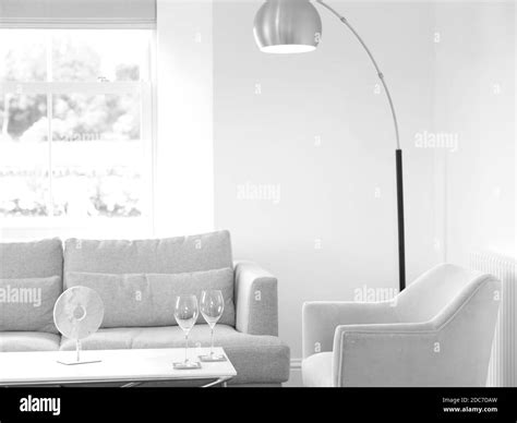 Modern Contemporary Lounge Interior with grey sofa and yellow armchair with floor standing gold ...