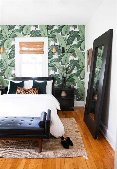 Removable banana leaf wallpaper from Etsy adds a tropical touch to one of the guest rooms, which ...