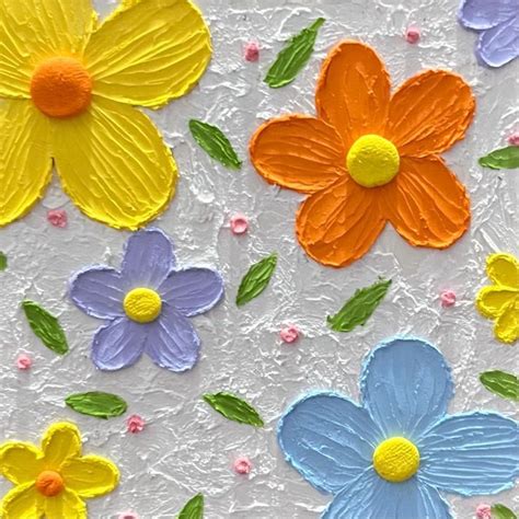 colorful paper flowers on white background with green leaves and pink, blue, yellow, orange, and ...