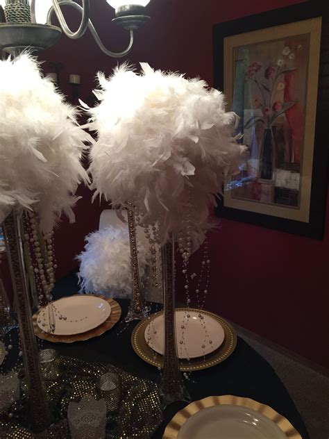 Feather boa 'bouquets' for table centerpieces on 24" clear vases filled with gold spray painted ...