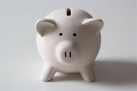 Close Up Photo of White Piggy Bank with several 50 Euro Banknotes on White Background - Creative ...