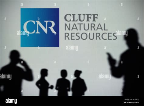 The Cluff Natural Resources logo is seen on an LED screen in the background while a silhouetted ...