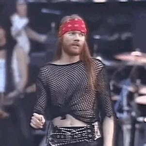 a woman with a bandana on her head is walking down the runway at a music festival
