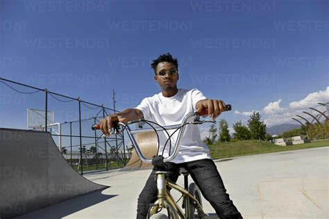 Young man sitting on BMX bike stock photo