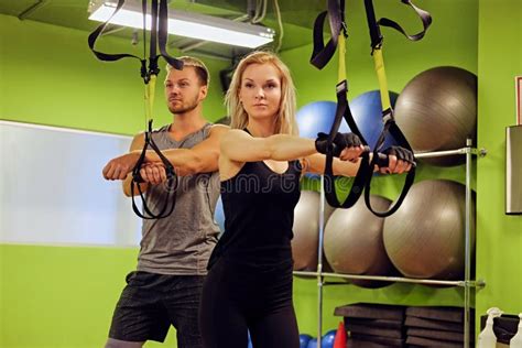 Sporty Male and Female Doing Trx Straps Exercises in a Gym Club. Stock ...