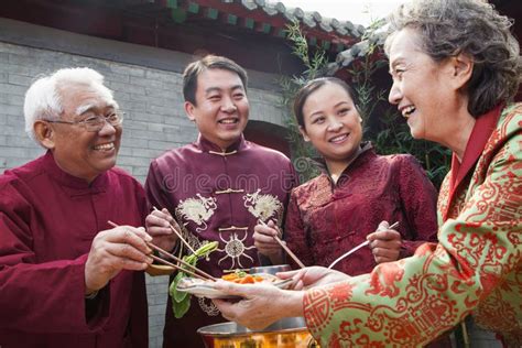 Family Enjoying Chinese Meal In Traditional Chinese Clothing Stock ...