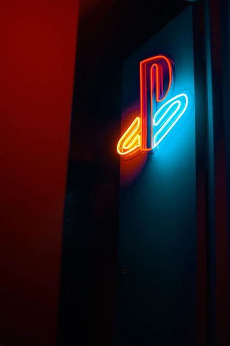 a neon sign that is on the side of a wall in front of a mirror