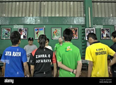 Young badminton players are given instructions during a training ...