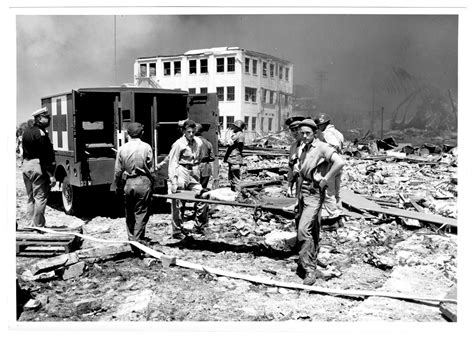 [Rescue workers holding a stretcher near an ambulance after the 1947 ...