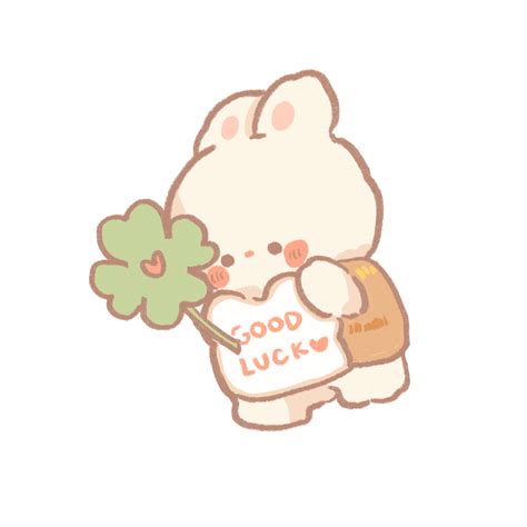 a white cat holding a green leaf in it's hand with the words good luck written on it