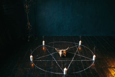 Premium Photo | Pentagram circle with candles on black wooden floor ...