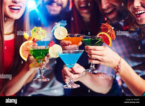 Young people drinking cocktails at nightclub Stock Photo - Alamy