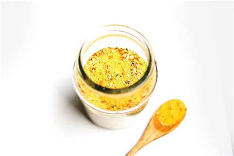Yellow all purpose mix seasoning in jar with wooden spoon on white background - Creative Commons ...