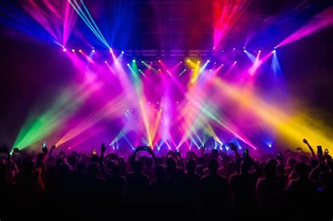 Premium AI Image | a crowd of people at a concert with bright lights